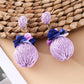 Earedge raffia ball earrings shown from above highlighting texture and color