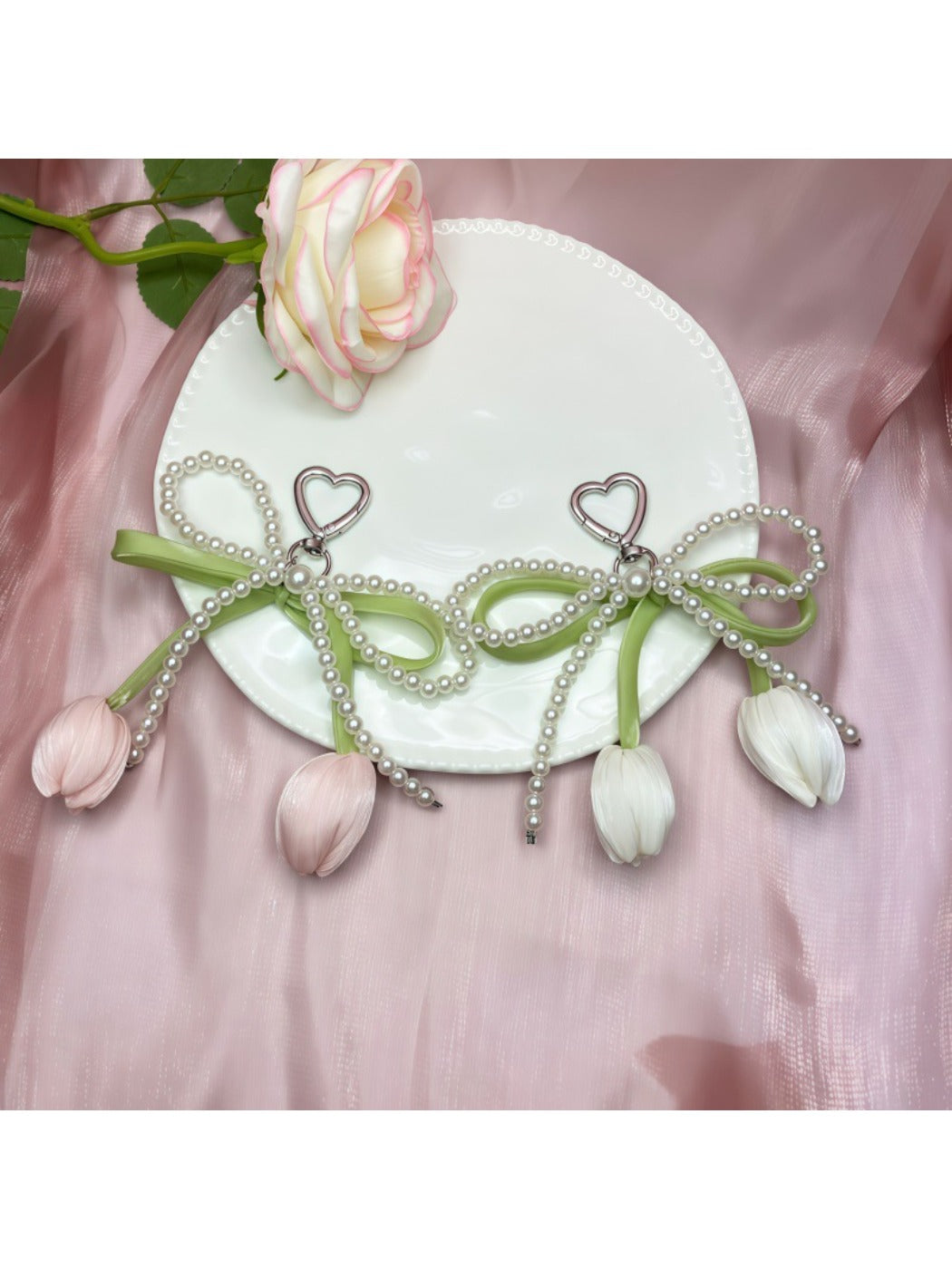 Side view of the bow and tulip pendant keychain with metal ring
