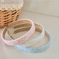 Top view of Gifty Dreamy Sparkly Sweet Headband highlighting glitter texture and bow shape