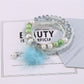 Detailed shot of colorful beads and pink pompom pendant on Lovra bracelet
