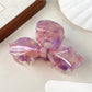 Beau iridescent bow hair claw clip styled in long hair