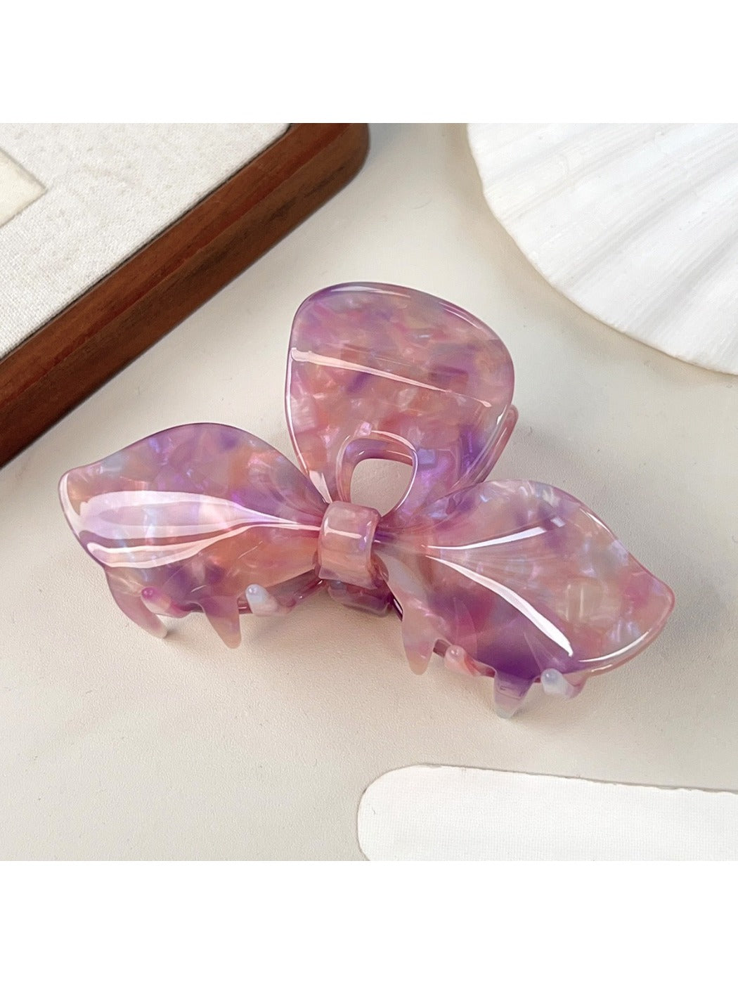 Beau iridescent bow hair claw clip styled in long hair