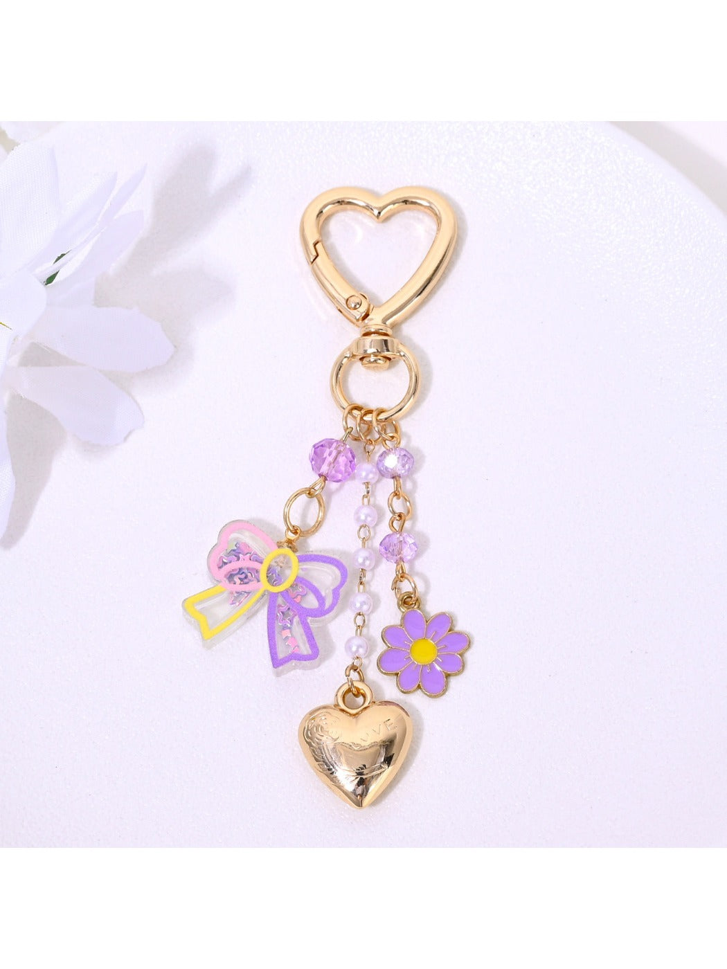 Keypus heart and flower keychain displayed on wooden surface