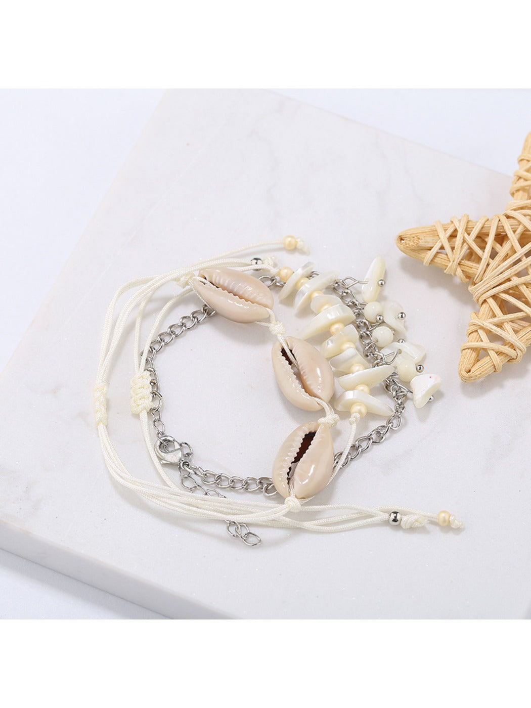 Lovra bracelet displayed on a wooden surface with seashells and beach decor