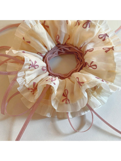 Gifty scrunchie worn on wrist highlighting bow design