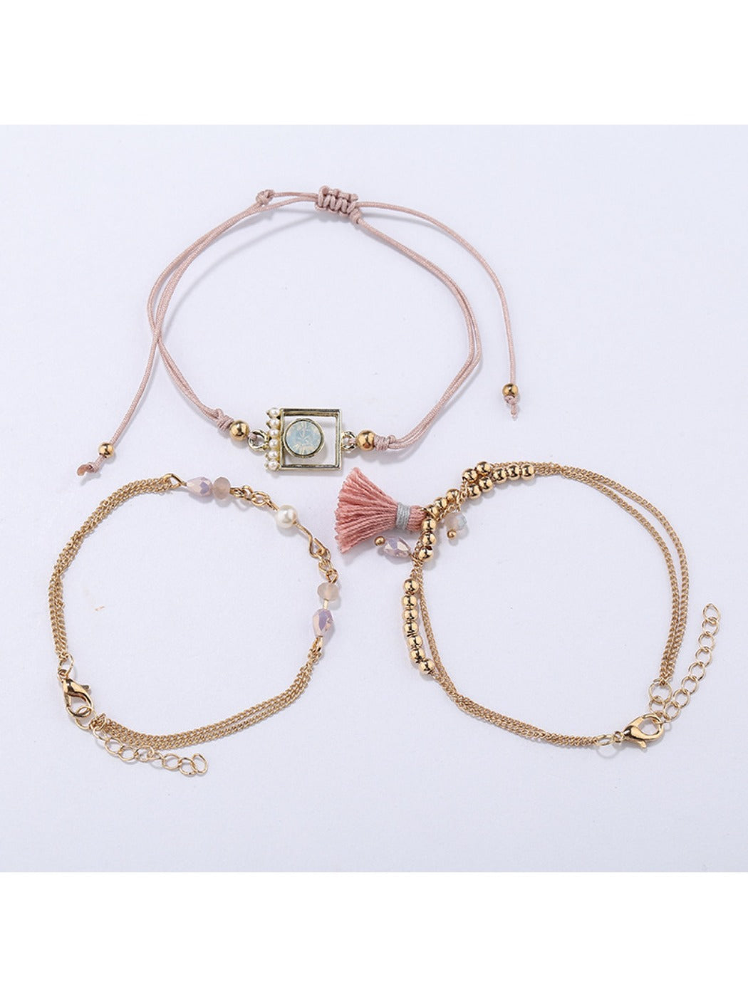 Lovra small bead bracelet featuring a gold tassel pendant on a wrist