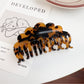 Beau double row wavy claw clip resting on a white surface