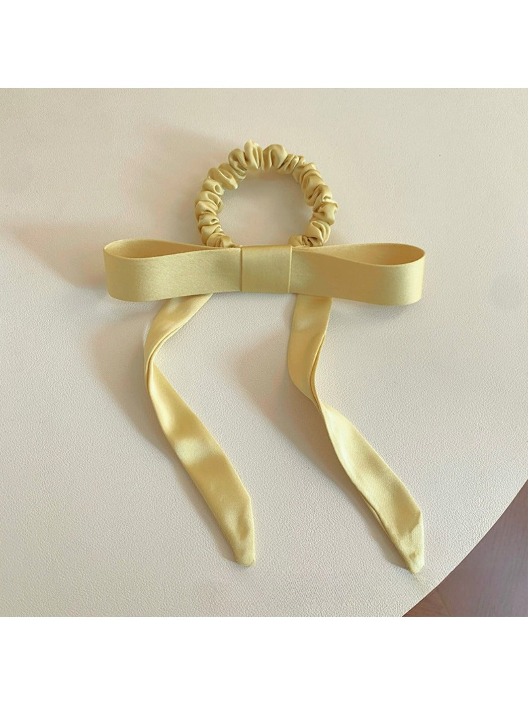 Gifty satin yellow ribbon bow scrunchie with soft sheen and gathered elastic