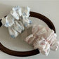 Gifty Sweet Lace Tiny Floral Scrunchie worn on a wrist as a stylish accessory