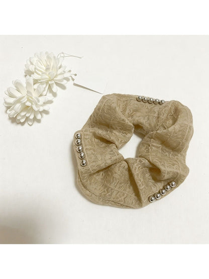 Model wearing Gifty lace scrunchie in hair, highlighting its soft and elegant design
