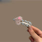 Close-up of plaid beaded heart hair clip highlighting bead details
