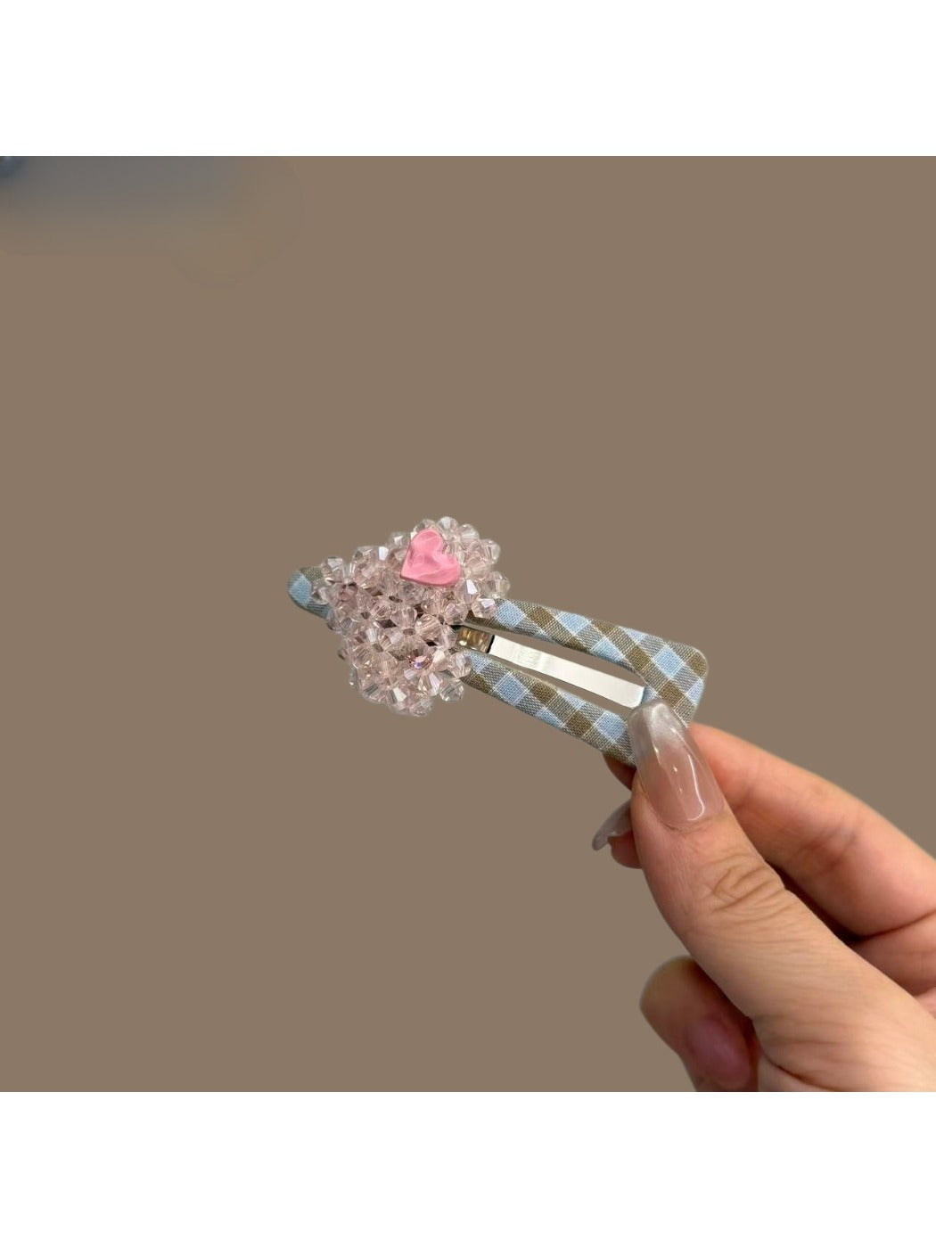 Close-up of plaid beaded heart hair clip highlighting bead details