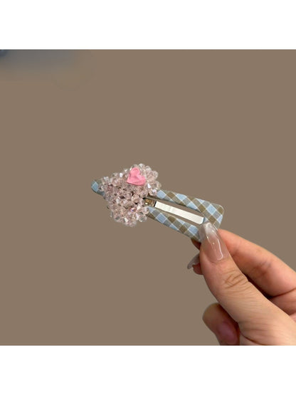 Close-up of plaid beaded heart hair clip highlighting bead details