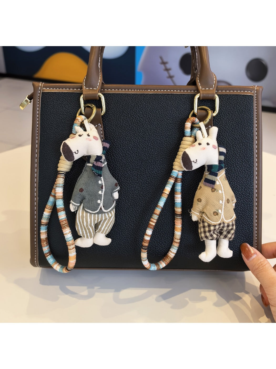 Giraffe charm keychain attached to a set of keys on a wooden surface