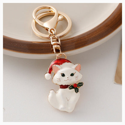White Christmas cat keychain with Santa hat and holly