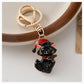 Black Christmas cat keychain with Santa hat and holly