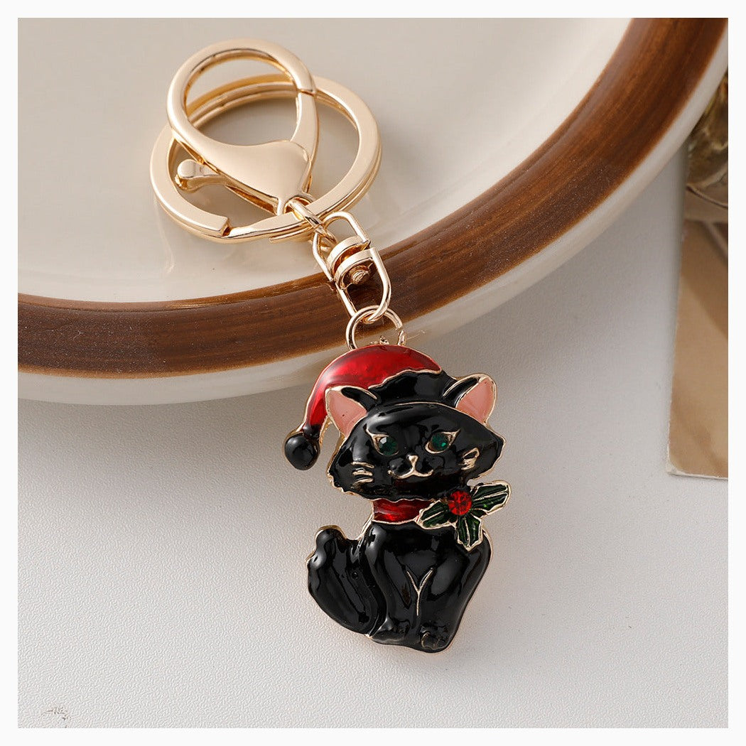 Black Christmas cat keychain with Santa hat and holly