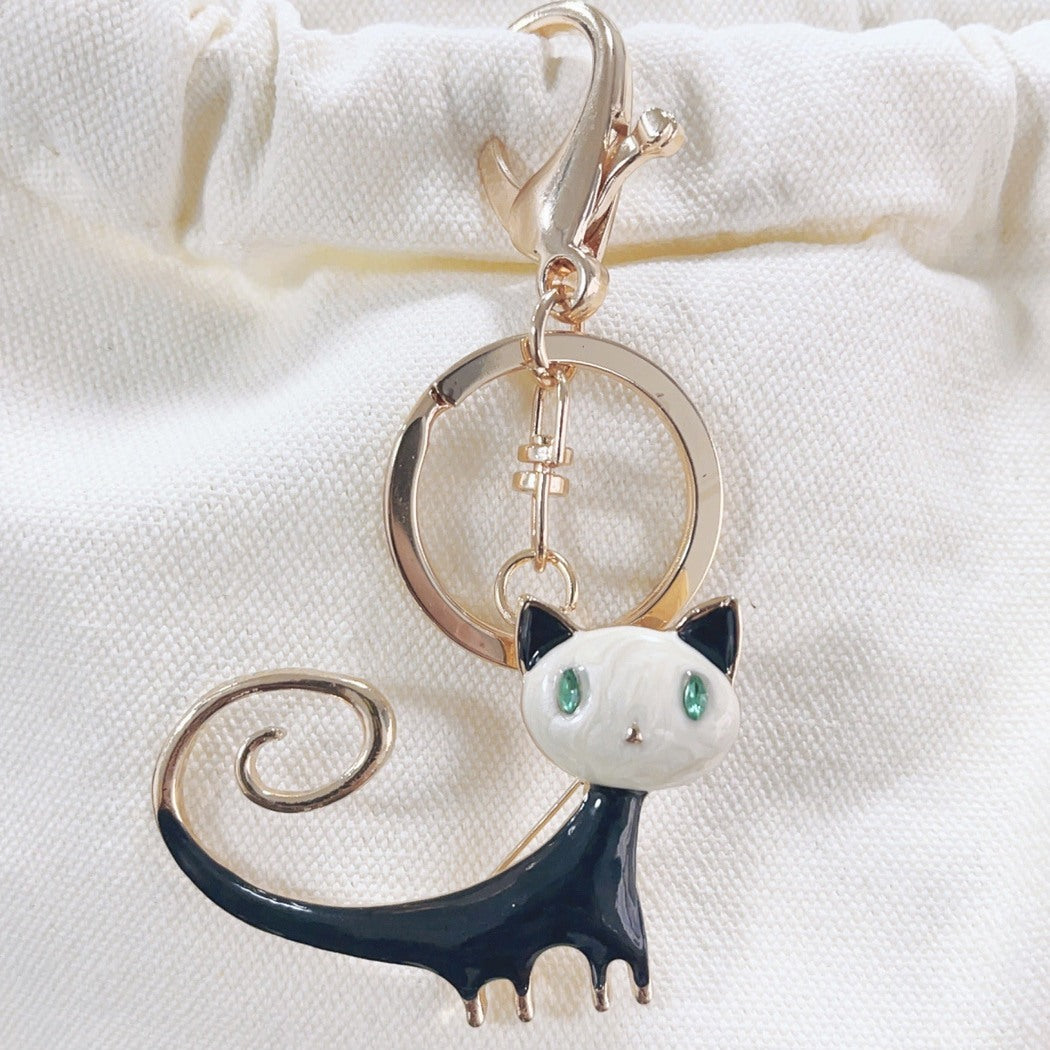 Black and white abstract cat keychain on fabric