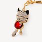 Red faceted cat keychain on neutral background