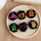Six Halloween character tulle hair clips arranged together
