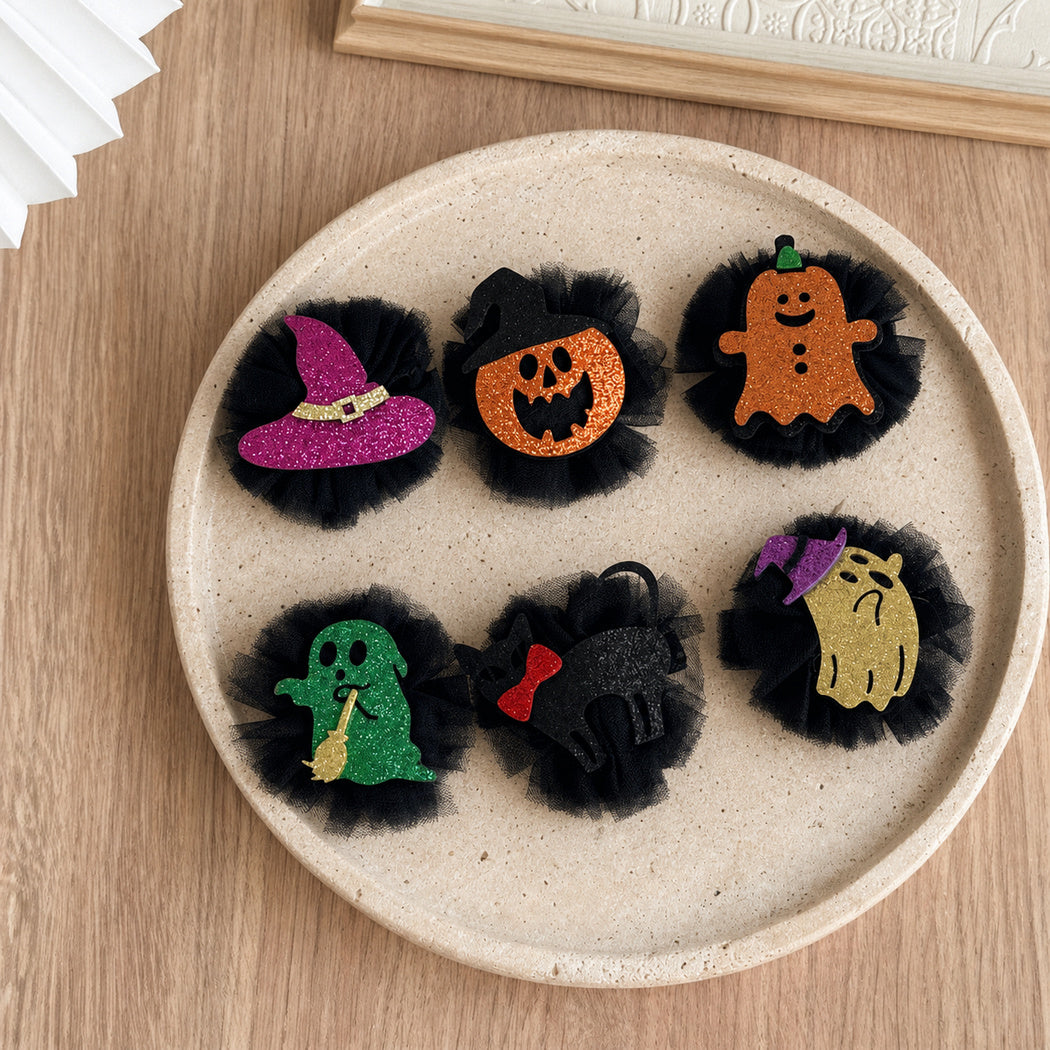 Six Halloween character tulle hair clips arranged together
