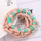 Lovra bracelet worn on wrist featuring rhinestone pendant and vibrant beads