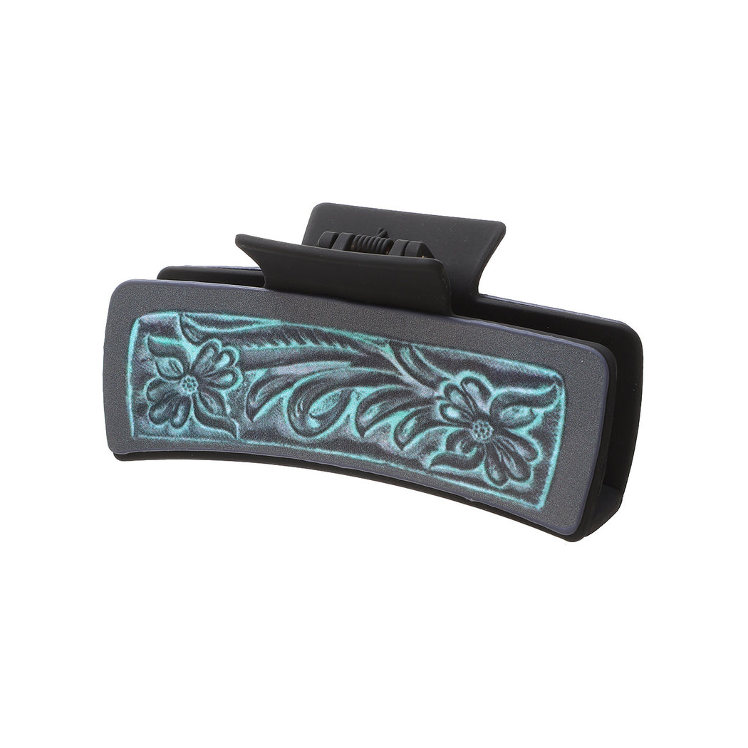 Turquoise floral hair claw on white background