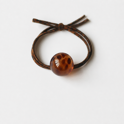 Brown leopard bead hair tie on clean white background