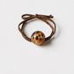 Gold transparent leopard bead hair tie on clean white background