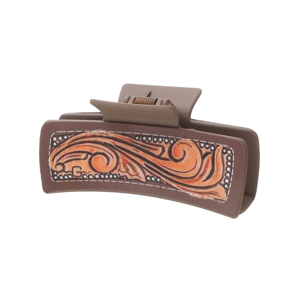 Orange scroll hair claw on white background