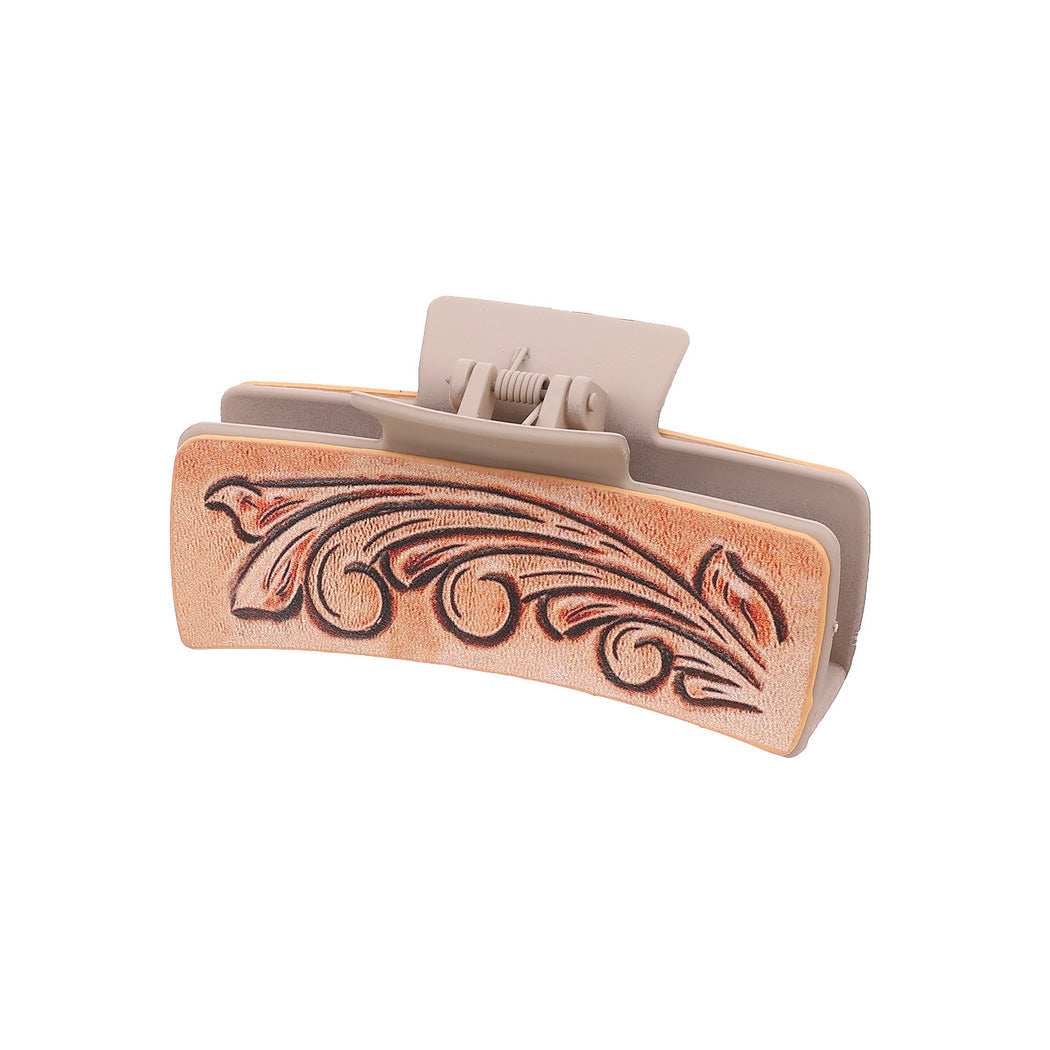 Peach scroll hair claw on white background