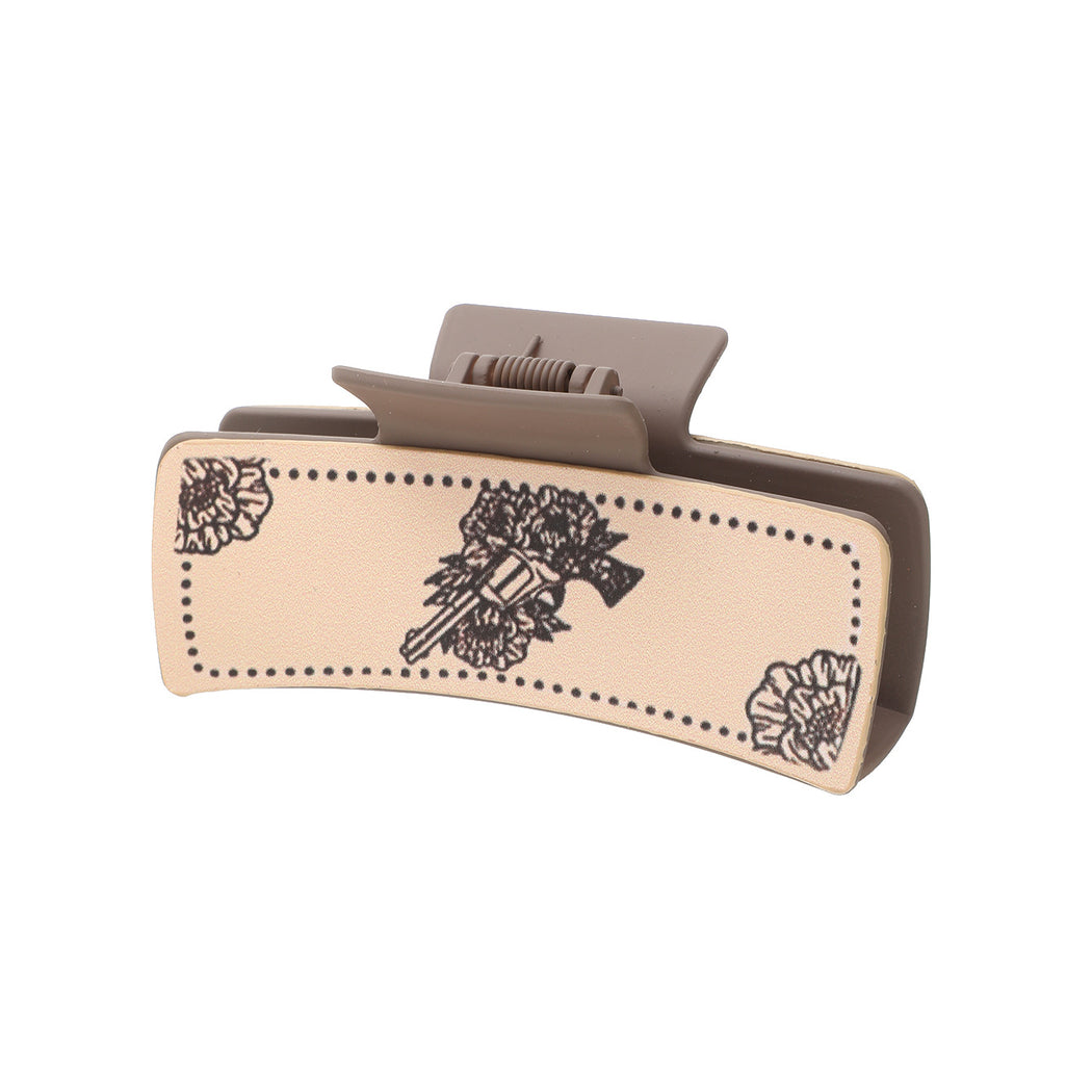 Arrow and floral hair claw on white background