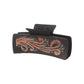 Orange scroll hair claw on white background