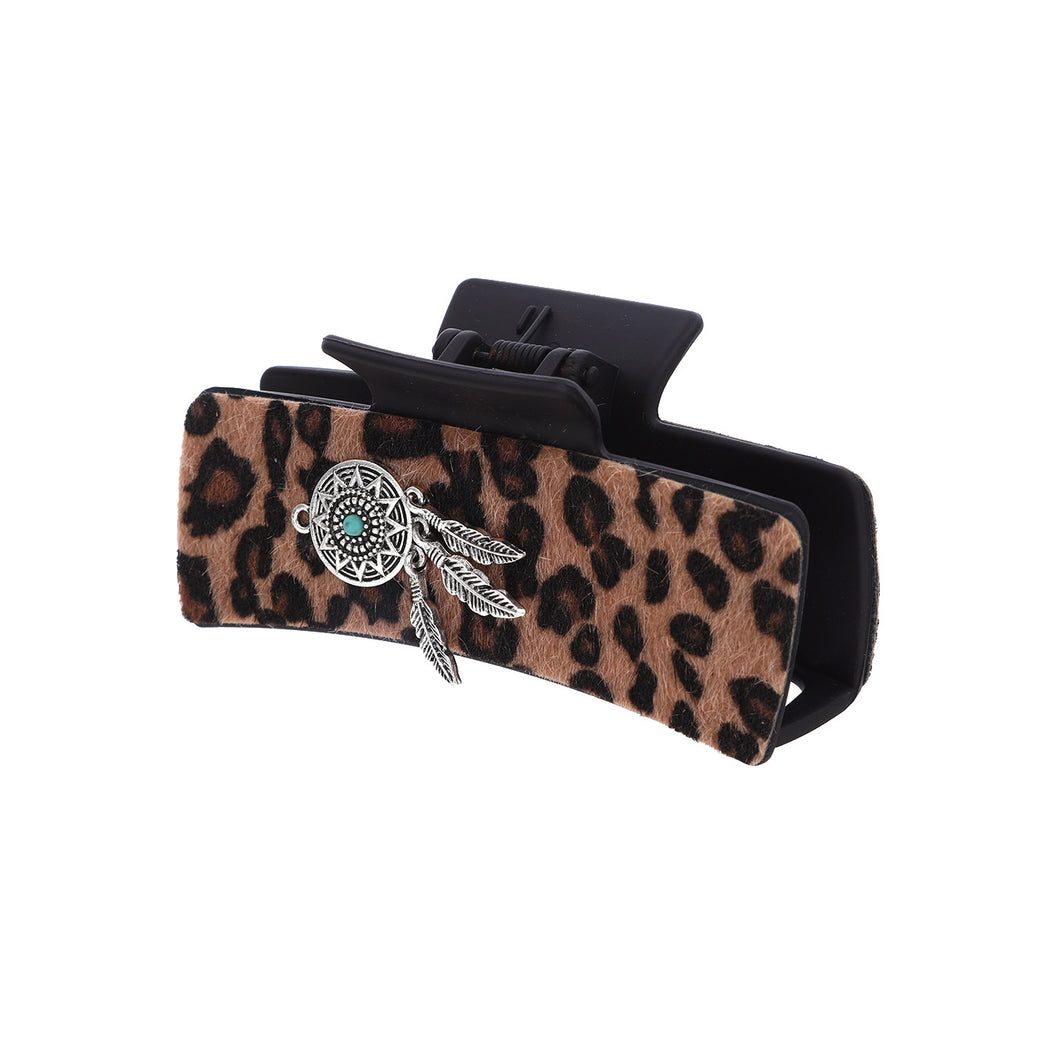 Leopard and turquoise hair claw on white background