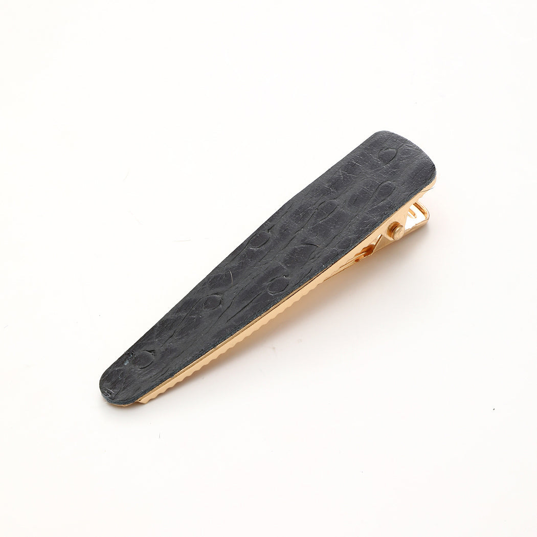 Black crocodile texture elongated barrette on white background
