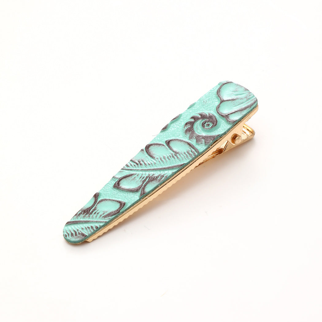 Turquoise floral elongated barrette on white background