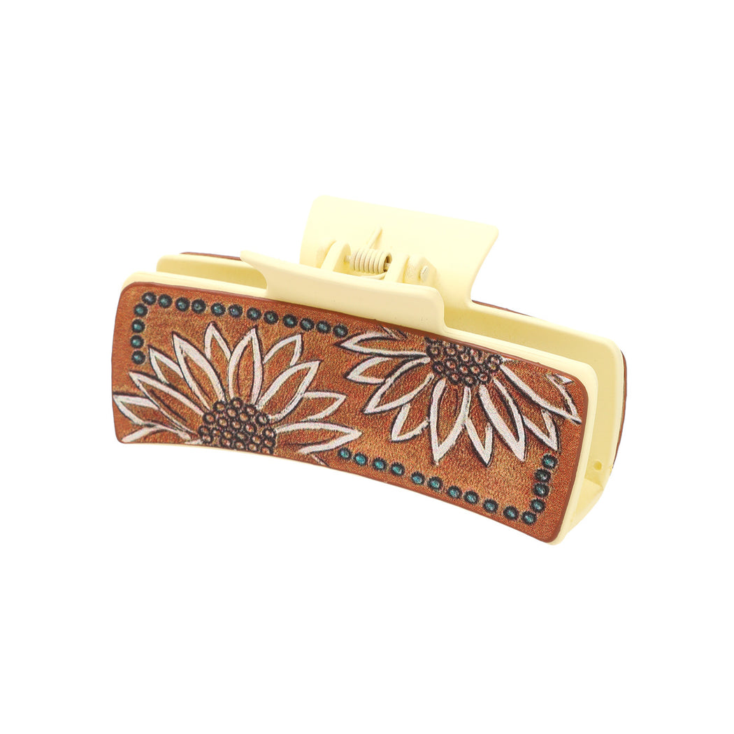 White-outlined sunflower hair claw on white background