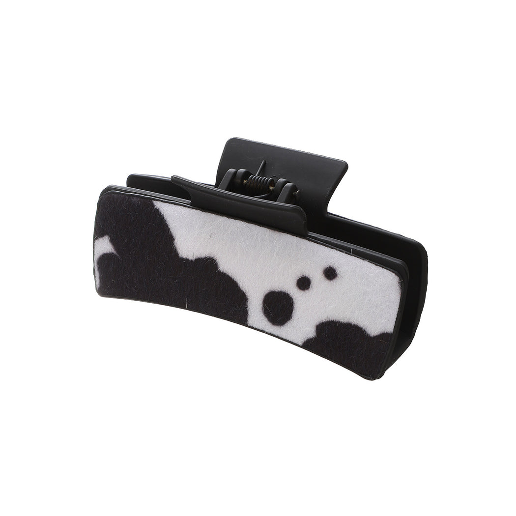 Black cow print hair claw on white background