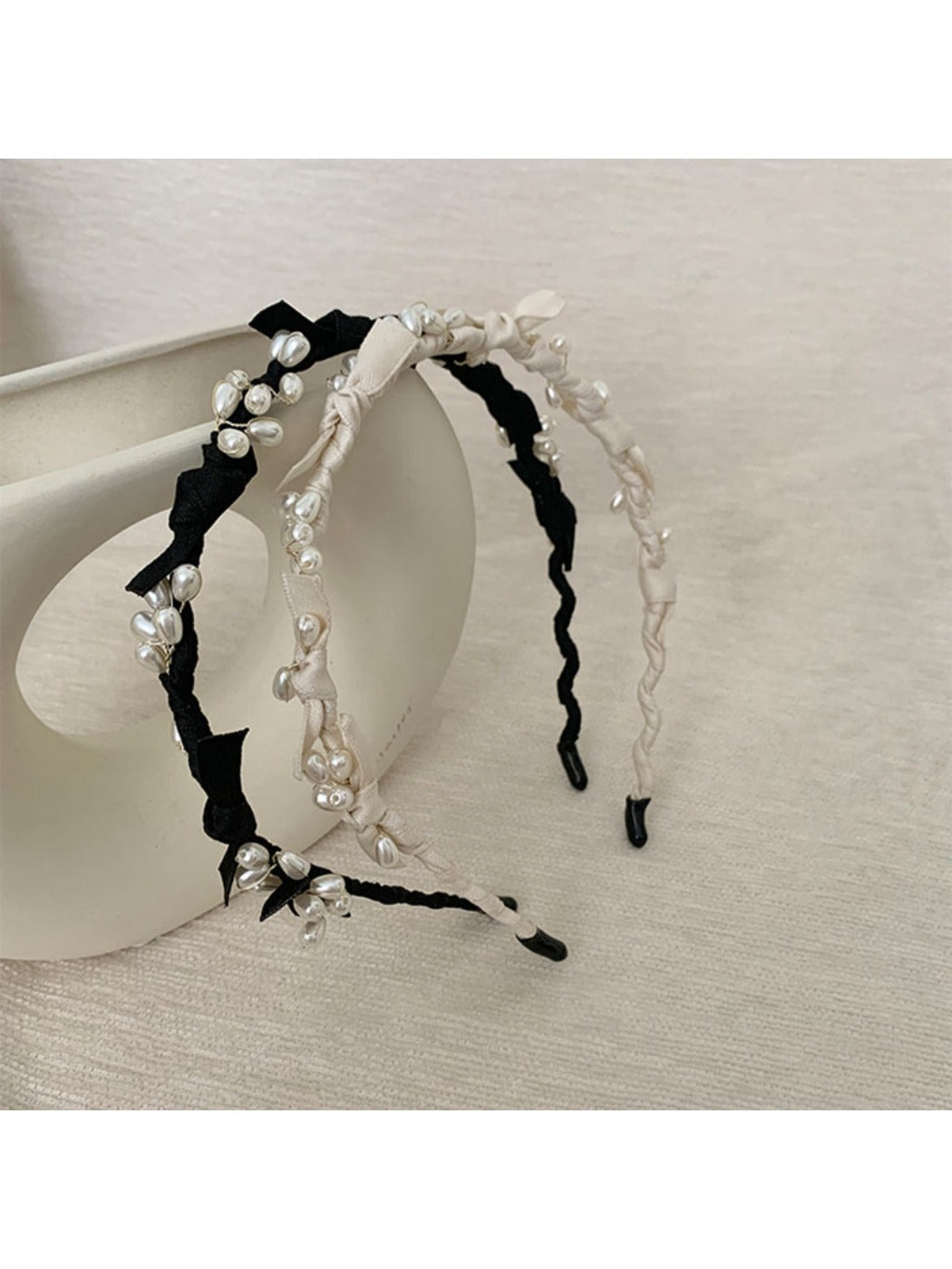 Top view of Gifty Sweet Oval Bead Bow Headband displaying symmetrical bead pattern