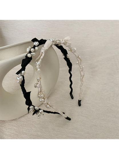 Top view of Gifty Sweet Oval Bead Bow Headband displaying symmetrical bead pattern
