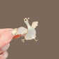 Winged goose iridescent brooch, front view