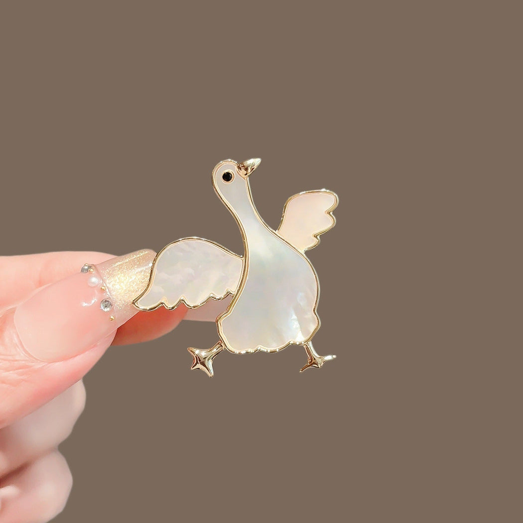 Winged goose iridescent brooch, front view