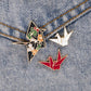 Origami crane geometric brooch in three visible styles, overview