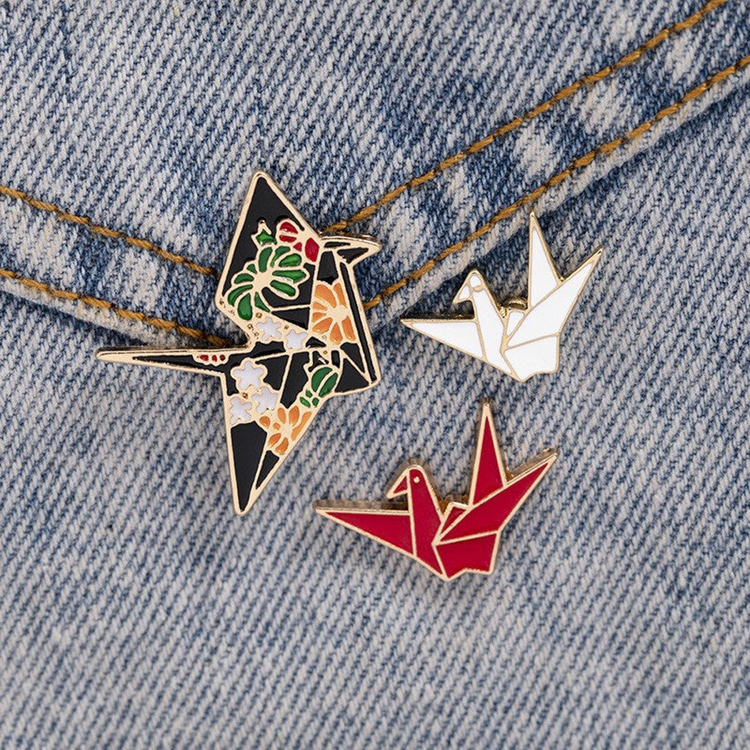 Origami crane geometric brooch in three visible styles, overview