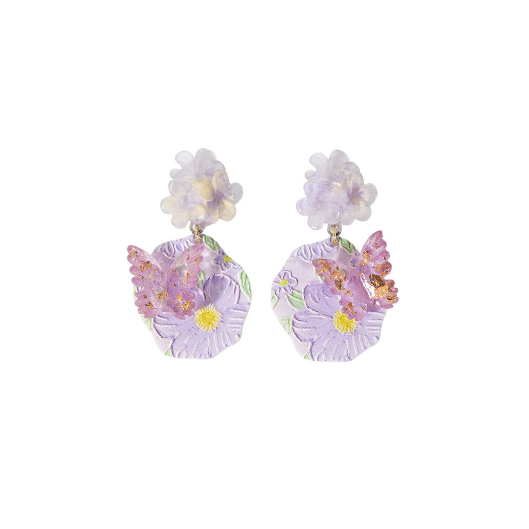 Purple floral cluster drop earrings, front view