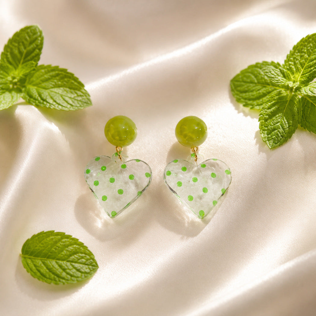 Green polka dot heart drop earrings, front view