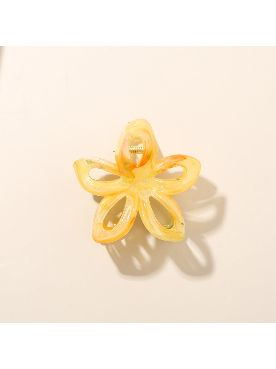 Beau hair clip attached to a ponytail, featuring a vibrant flower shape