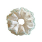 White tulle double scrunchie with green trim displayed on a hand
