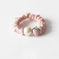 Strawberry hair tie packaged in a clear plastic bag with branding label