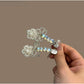 Beau bow hair clip worn in styled hair, highlighting sparkle and design